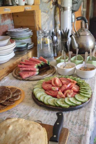 a table topped with plates of food on a table at The house in the village in Tirana