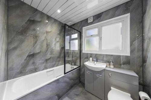 a bathroom with a sink and a toilet and a window at Beautiful 3 bedroom Home in Cambridgeshire in Easton on the Hill