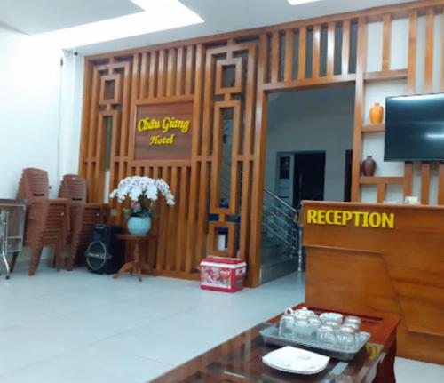 a room with a reception desk and a television at Châu Giang Hotel Cửa Lò in Cửa Lô