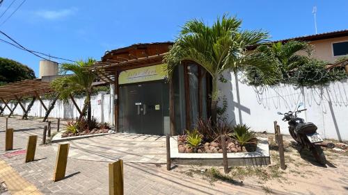 a motorcycle parked in front of a building at Loft Solar Água in Pipa