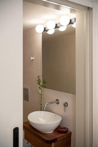 a bathroom with a white sink and a mirror at Faedra Residence in Chania Town