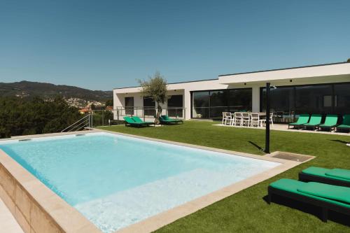 a swimming pool on the roof of a house at Casa dos Mirtilos Legacy T7 in Celorico de Basto