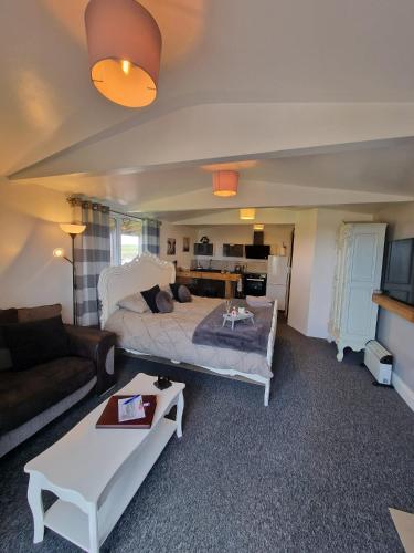 a living room with a bed and a couch at The Viewpoint in Deal