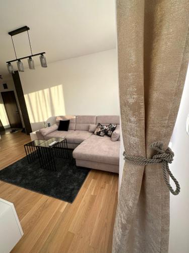 a living room with a couch and a table at Apartman EMA in Banja Luka