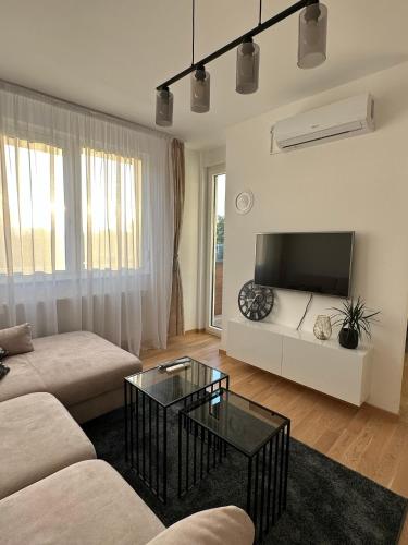 a living room with a couch and a tv at Apartman EMA in Banja Luka