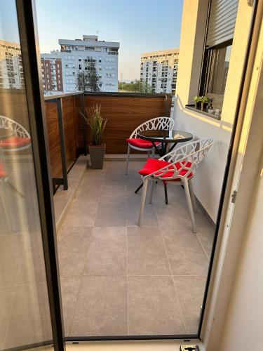 a balcony with a table and chairs on a roof at Apartman EMA in Banja Luka