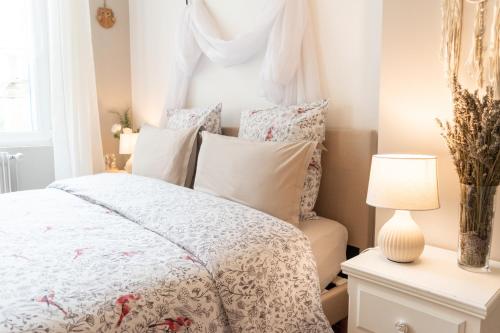 a bedroom with a white bed and a window at La Fée Maison in Châtel-sur-Moselle