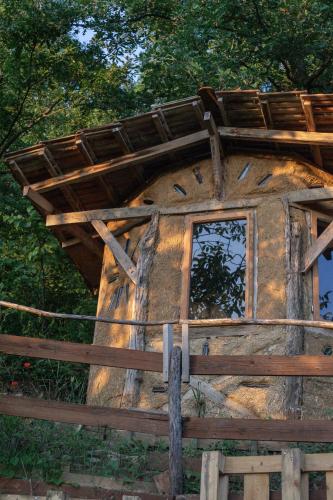 a log cabin with a window and a fence at The house in the village in Tirana