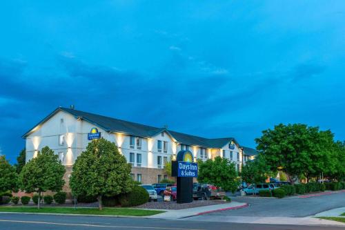 a hotel with a sign in front of a building at Days Inn & Suites by Wyndham Denver International Airport in Denver