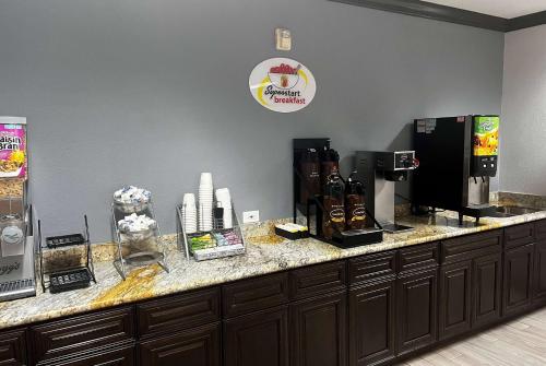a counter in a coffee shop with a coffee maker at Super 8 by Wyndham Port Arthur/Nederland Area in Port Arthur