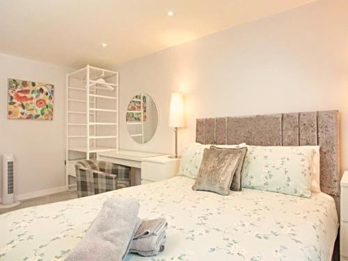 a bedroom with a large bed and a desk at Number 10, Montpellier Apartments, Teignmouth in Teignmouth
