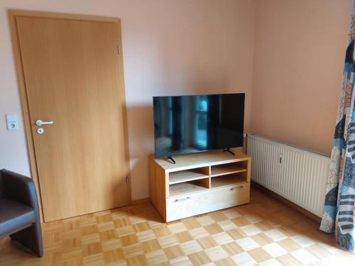 a flat screen tv sitting on a stand in a room at Ruhe genießen und wohlfühlen auf 70m² in Ober-Laudenbach