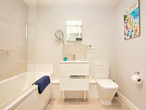 a bathroom with a toilet and a sink and a bath tub at Number 10, Montpellier Apartments, Teignmouth in Teignmouth