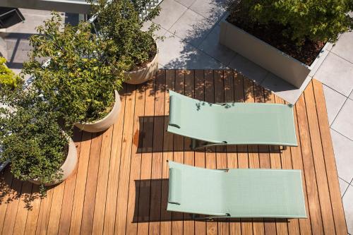 an overhead view of two tables and potted plants on a deck at Le Pélican in Annecy