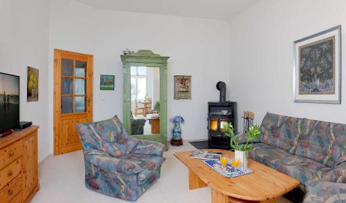 a living room with a couch and a wood stove at Dünenstraße 25 in Zinnowitz
