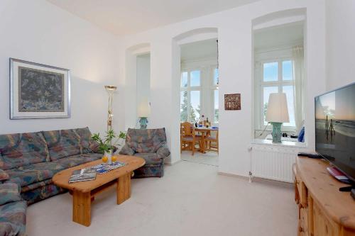 a living room with a couch and a coffee table at Dünenstraße 25 in Zinnowitz