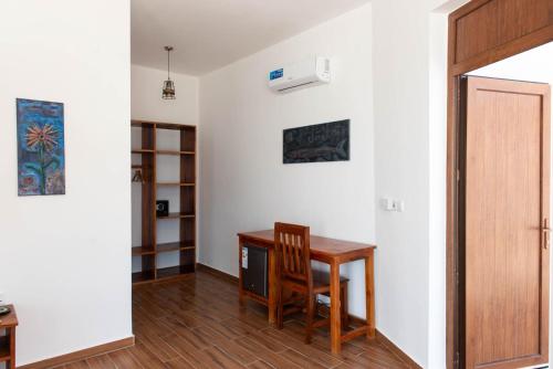 a room with a desk and a chair and a door at S&S HOTEL in Jambiani