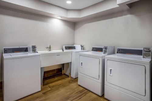 a room with three washing machines and a sink at Days Inn by Wyndham Pleasant Prairie Kenosha in Kenosha