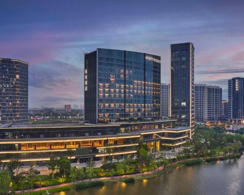 a city skyline with tall buildings and a river at Hyatt Regency Shanghai Songjiang in Songjiang