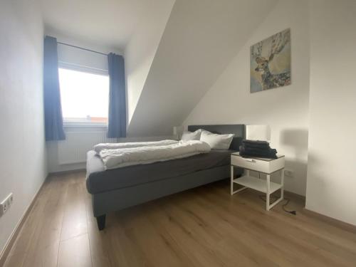 a small bedroom with a bed and a window at Air Apartments 2 in Bremen