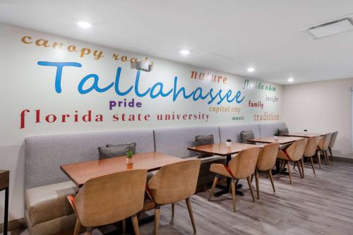 a restaurant with tables and chairs in a room at TRYP by Wyndham Tallahassee North I-10 Capital Circle in Tallahassee