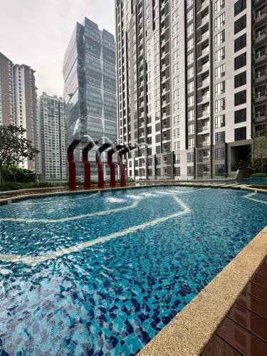 a swimming pool in a city with tall buildings at Sentral Suites KualaLumpur in Kuala Lumpur