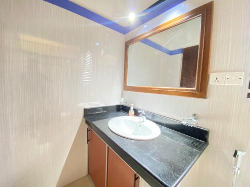 a bathroom with a sink and a mirror at New Sea Villa in Negombo