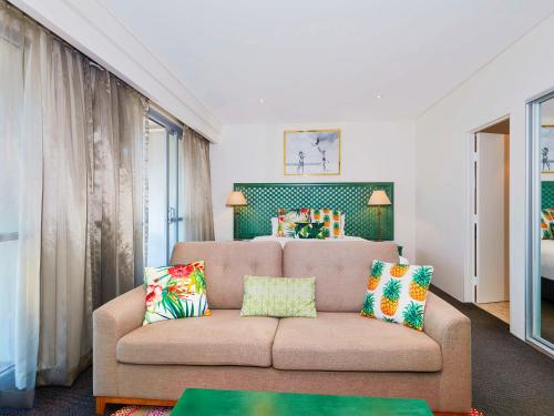 a living room with a couch and a bed at Peppers Manly Beach in Sydney