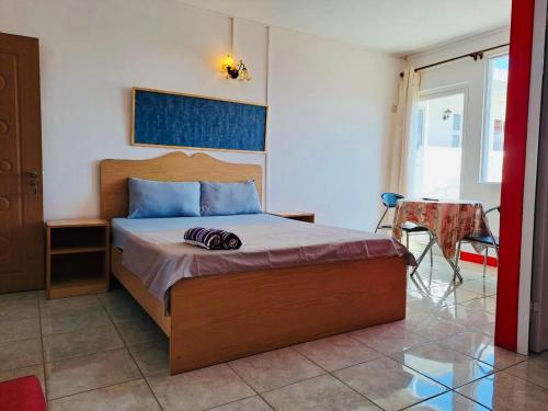 a bedroom with a bed and a table and a chair at Spacious Private Rooms with Communal Kitchen in Grand Gaube