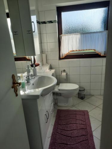 a bathroom with a sink and a toilet at Apart in Bremerhaven