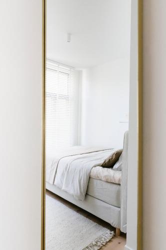 a mirror reflecting a bed in a bedroom at High-end flats at South area in Antwerp