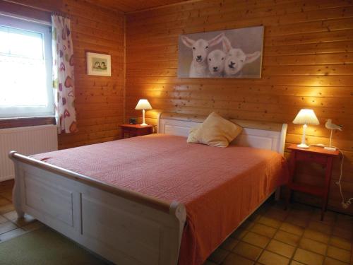 a bedroom with a bed with two animals on the wall at Ferienwohnung im Ferienhaus Kästner in Friedrichskoog