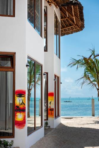 a building on the beach with a view of the ocean at S&S HOTEL in Jambiani