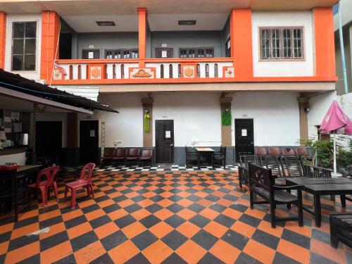 an empty patio with tables and chairs in a building at Vientiane Star Hotel in Vientiane