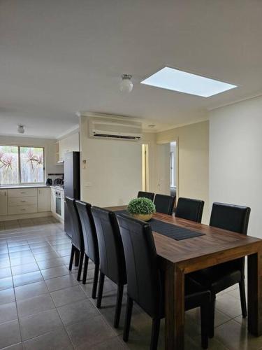 a dining room with a wooden table and chairs at Beach Haven in Rosebud