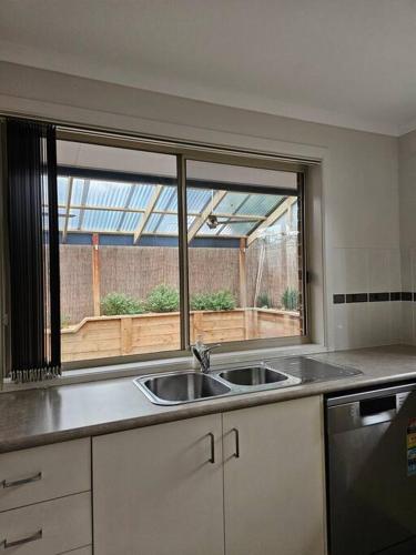 a kitchen with a sink and a window at Beach Haven in Rosebud