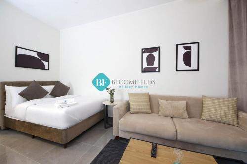ein Wohnzimmer mit einem Bett und einem Sofa in der Unterkunft Furnished Studio With Huge Balcony in Al Qurayyah