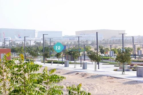 a street sign in the middle of a park at Furnished Studio With Huge Balcony in Al Qurayyah