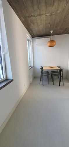a dining room with a table and two windows at Lemon Villa in Lagos