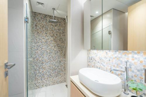 a bathroom with a sink and a shower at Modern 2 Br Maid's Room With Amazing View in Abu Dhabi