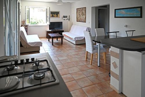 a kitchen and living room with a stove at Apartments Antica in Vrboska