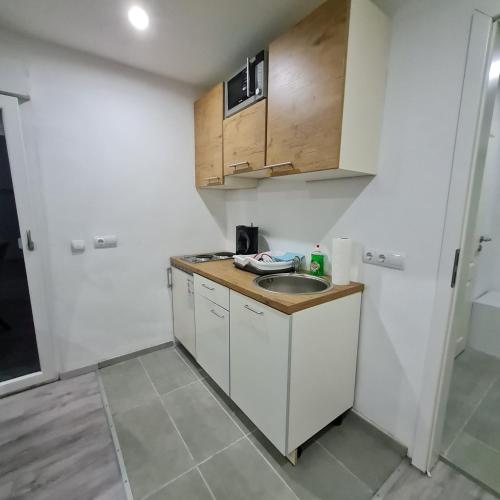 a small kitchen with a sink and a refrigerator at Klein und ruhig! Apartment zum entspannen in Pfungstadt
