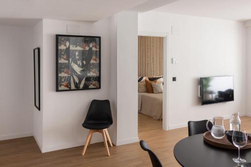 a living room with a table and a couch at VLC Host - Lleons Cityscape in Valencia