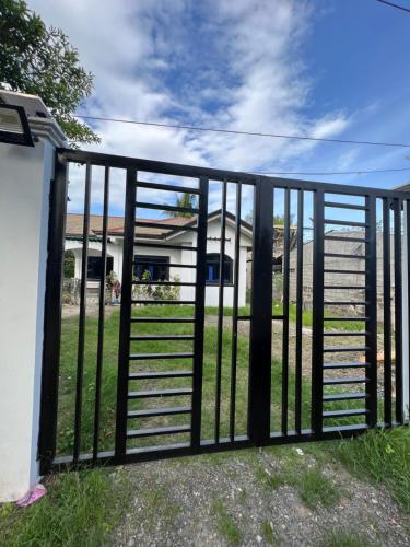 a gate in a yard with a fence at Cordon, Isabela Staycation House in Cordon