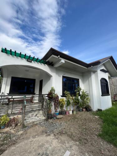 a white house with plants in front of it at Cordon, Isabela Staycation House in Cordon