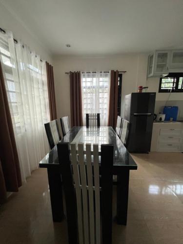 a dining room table and chairs in a kitchen at Cordon, Isabela Staycation House in Cordon