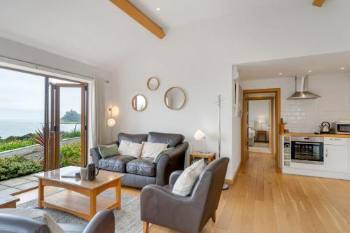 a living room with a couch and a table at Rosemerryn in Marazion