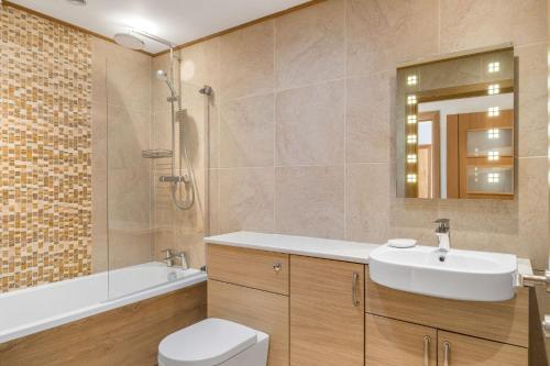 a bathroom with a sink and a toilet and a tub at Rosemerryn in Marazion