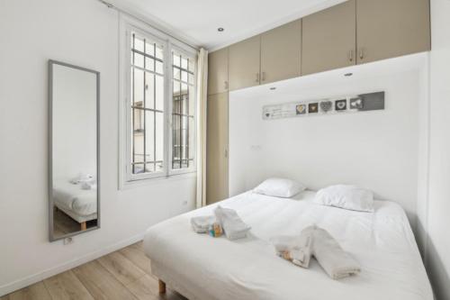 パリにある1022Lenyの白いベッドルーム(ベッド1台、鏡付)
