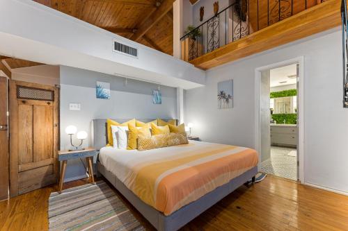 a bedroom with a king sized bed with yellow pillows at The Self-Sustainable Beach House in South Padre Island